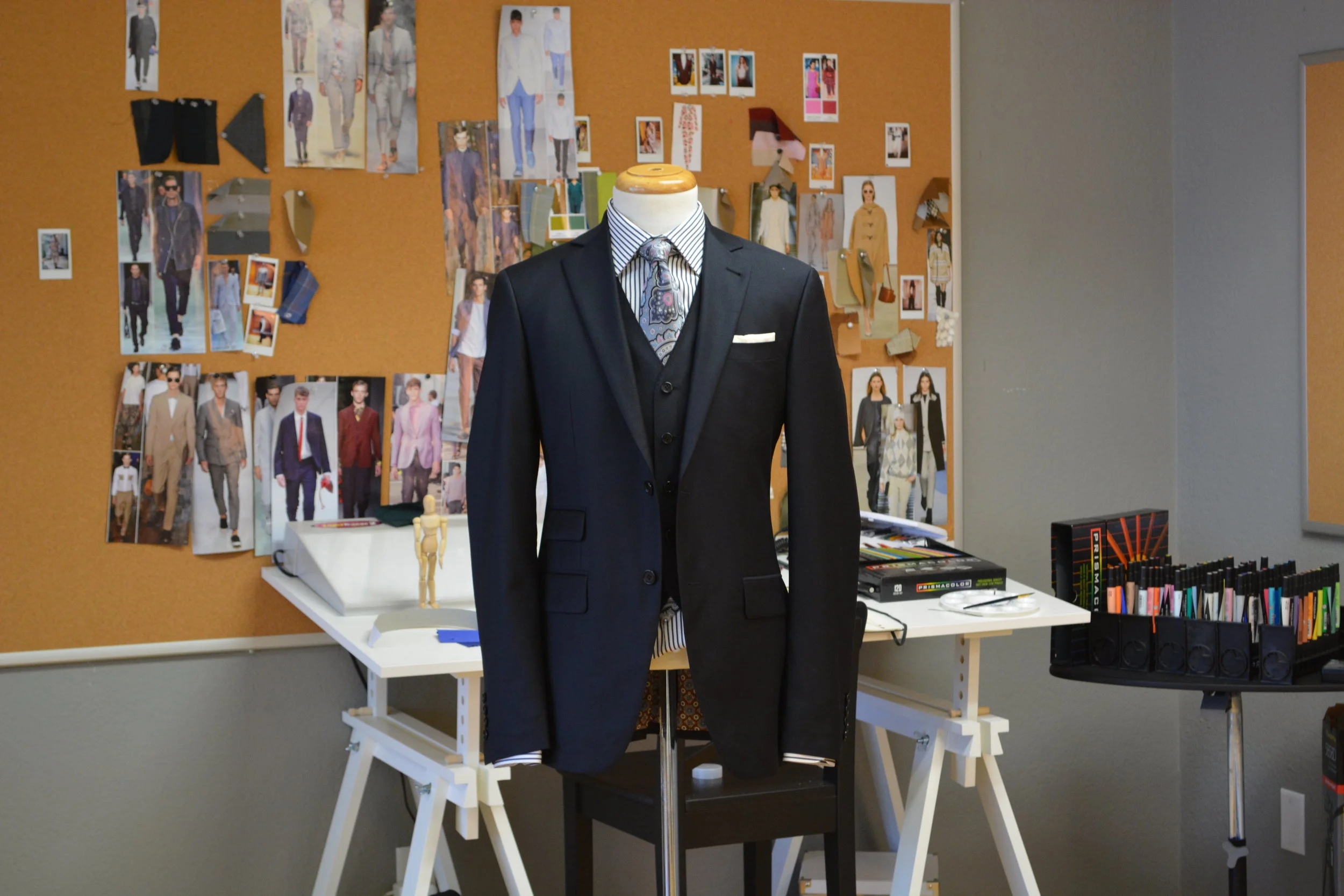 bespoke tailor shop, custom tailoring, tweed suit, suit alterations and restoration, vintage suit restoration, tailor sewing machine, artisan craftsmanship, menswear, wool fabric rolls, traditional tailoring.